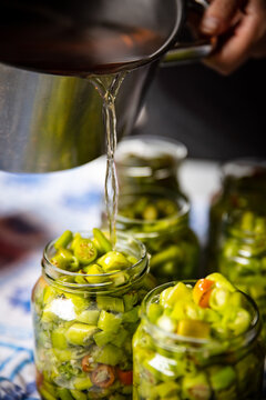 many green pepperonis sliced and placed in jars