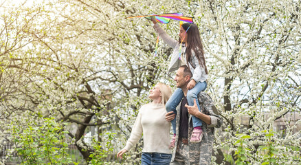 Soldier reunited with his family in park.
