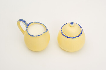 Top down view of milk creamer and sugar jar 