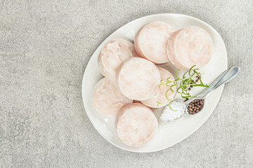 Chunks of frozen hake. Marine fish fillet on stone background, raw ingredient for cooking food
