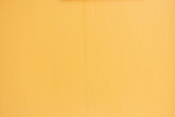 Grunge cracked yellow color concrete wall textured background as loft style