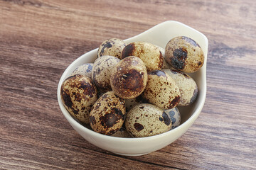 Raw quail eggs heap in the bowl