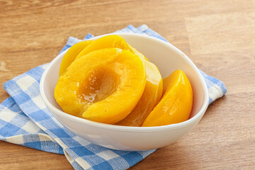 Sweet canned peaches with syrope