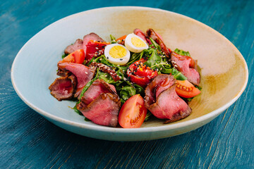 Veal carpaccio with arugula and eggs