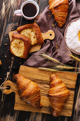 Brown crispy croissants on a wooden tray