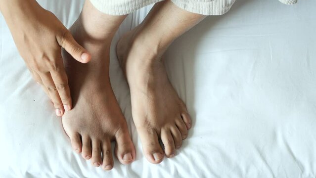 Close up on women feet and hand massage on injury spot.