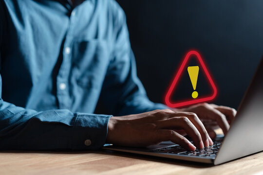 Businessman Or It Staff , Programmer, Developer Using Computer Laptop With Triangle Caution Warning Sign For Notification Error And Maintenance