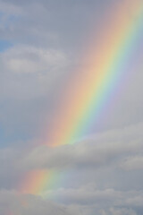Fototapeta na wymiar Close up of a beautiful rainbow between the clouds
