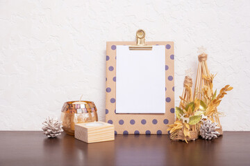 Mock up tablet with sheet paper and Christmas New Year decorations still life. Xmas text blank