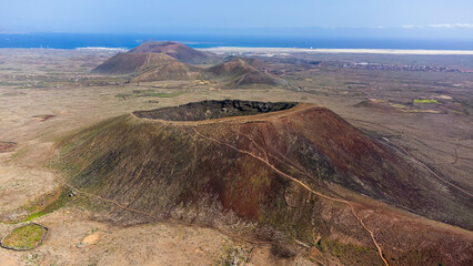 Aerial view of the caldera of the volcano Calderon Hondo in the north of Fuerteventura in the Canary Islands, Spain - obrazy, fototapety, plakaty