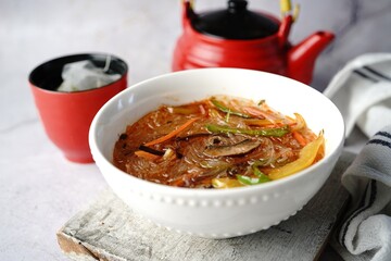 Spicy glass noodles soup with vegetables, selective focus