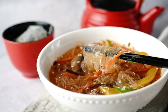 Spicy glass noodles soup with vegetables, selective focus