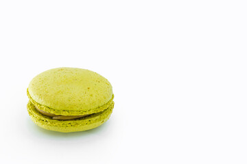 Green French macaroon isolated on white background. Tasty colorful macaroons. French pastry made from egg whites. Culinary and cooking concept.