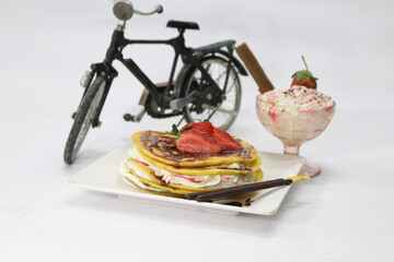Strawberry pancake with cream and chocolate