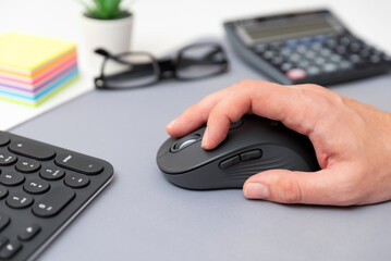 Man using computer mouse, office concept