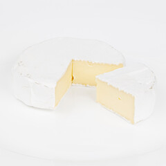 A piece of camembert cheese on a white background, a dairy product.