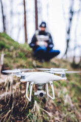 Man operating a drone while trekking in forest