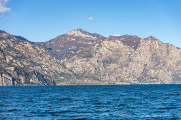 Small village of Limone sul Garda on the coast of Lake Garda (Lago di Garda) and Italian Alps, Brescia province, Lombardy, Italy, southern Europe. View from Malcesine, Verona province, Veneto.