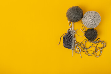 Balls of yarn and knitting needles. Needlework background.