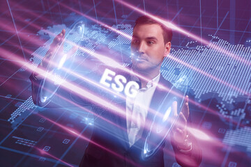 Business, Technology, Internet and network concept. Young businessman working on a virtual screen of the future and sees the inscription: ESG