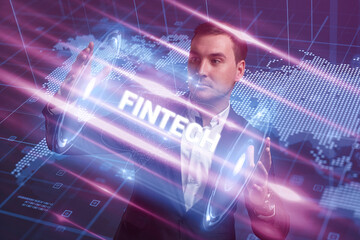 Business, Technology, Internet and network concept. Young businessman working on a virtual screen of the future and sees the inscription: Fintech