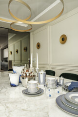 Large white veined marble dining table with crockery and cutlery