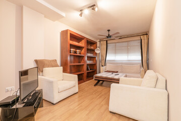 Living room with a wooden bookcase and a set of white fabric sofas