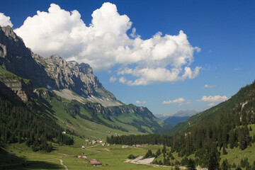 Fototapeta na wymiar Beautiful view to the valley and the green slopeson a sunny day,