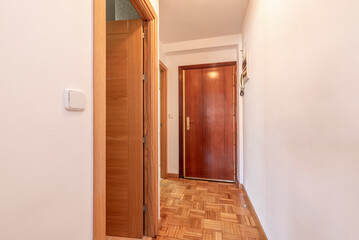 Entrance hall of the house with oak parquet checkerboard and armored access door