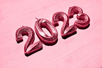 Festive background Happy New 2023 year. Side view, close-up. New 2023 trending PANTONE 18-1750 Viva...