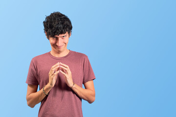 Young man with evil and funny face on flat lay.