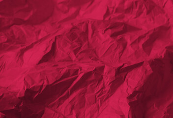 Crumpled paper Viva Magenta color of the year 2023. Texture crumpled paper for your design. Copy space. Viva Magenta color paper.