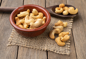 Cashew nuts in a bowl over wooden table
