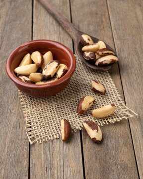 Brazil nuts in a bowl over wooden table