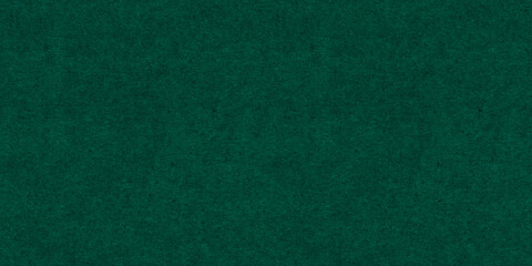 Seamless dark emerald green craft paper Christmas background texture. Rough textured thick cold pressed fibrous recycled cardboard or winter xmas holiday arts and craft card stock backdrop pattern..