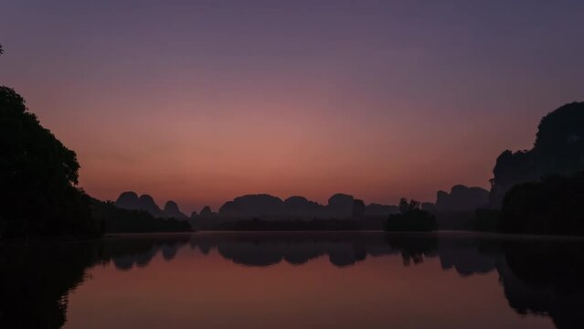 Nong Thale during sunrise, peaceful lake in Krabi, famous tourist destination for photography; night to day - Time Lapse
