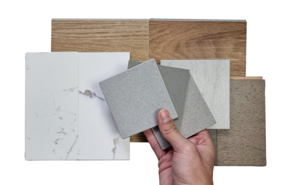 interior designer picking material samples including vinyl flooring tiles, marble quartzs, engineering flooring tiles, stone tile, artificial stones isolated on background with clipping path. 