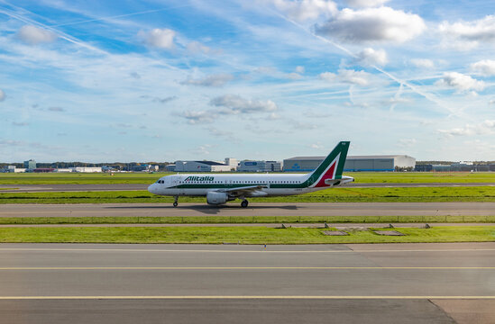 Amsterdam, Netherlands - October 19, 2022: A picture of an Airbus A320 Alitalia plane on the runway.