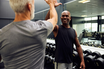 Men high-fiving after a gym workout