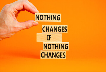 Nothing change symbol. Concept words Nothing changes if nothing changes on wooden blocks. Businessman hand. Beautiful orange table orange background. Business nothing changes concept. Copy space.