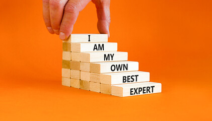I am my own best expert symbol. Concept words I am my own best expert on wooden blocks on a beautiful orange table orange background. Businessman hand. Business i am my own best expert concept.