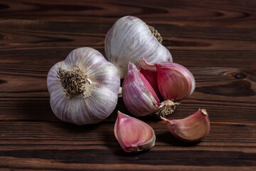 Garlic cloves on wooden table. Fresh peeled garlics and bulbs.