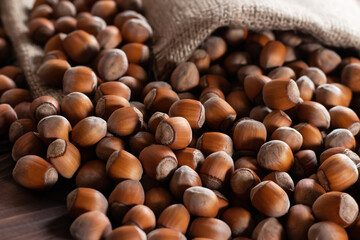 Hazelnuts, filbert on old wooden table. heap or stack of hazel nuts. Hazelnut background, healty food