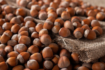 close up of hazelnuts on wooden table, top view