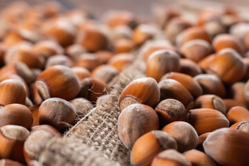 close up of hazelnuts on wooden table, top view