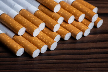 heap of cigarette on a wooden background
