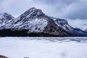 Fototapeta premium Ice is still frozen on Lake Minewnaka. Banff National Park, Alberta, Canada