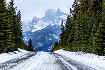 Snowy winter drive along the Minnewnaka Loop. Banff National Park, Alberta, Canada