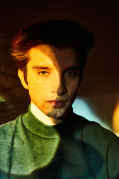 Young man in neon colorful illumination