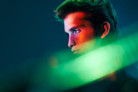 Young man profile in neon illumination